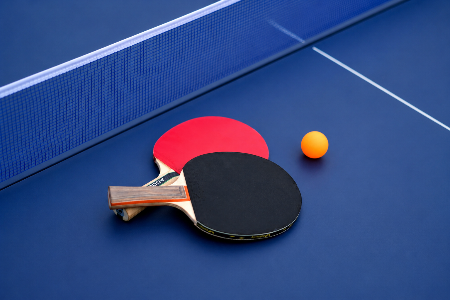 Table tennis bat and ball on a club table